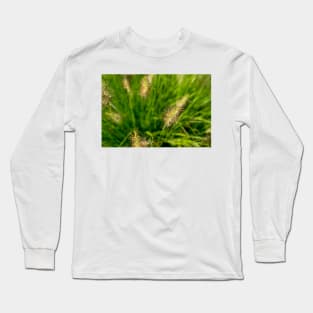 Bright spring grass field with sunlight bokeh background Long Sleeve T-Shirt